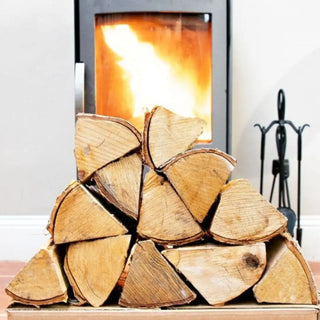 stacked logs in front of a fire