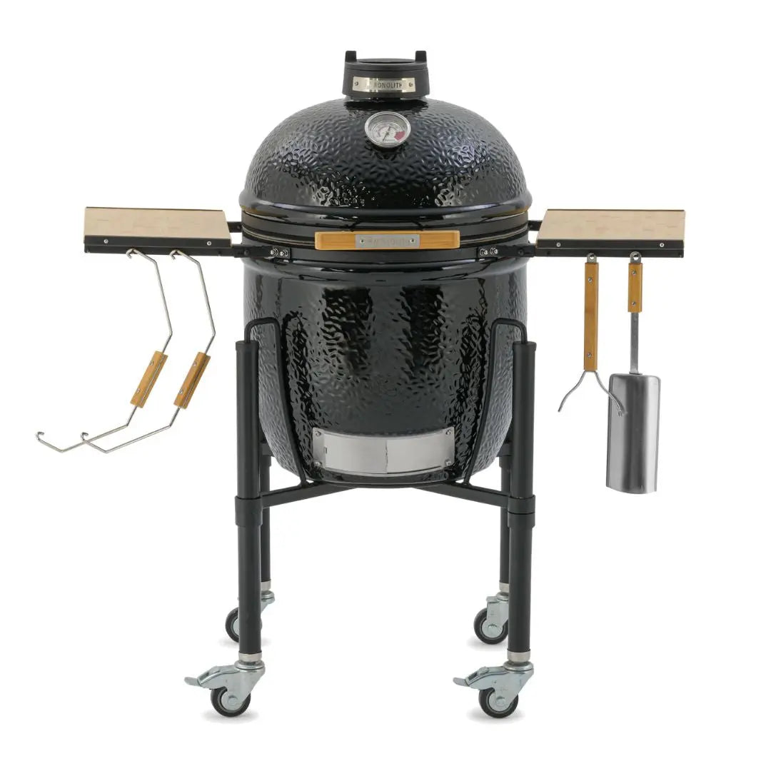 Monolith ONE 55cm Black ceramic kamado grill on wheels with wooden side tables closed view with accessories on a white background
