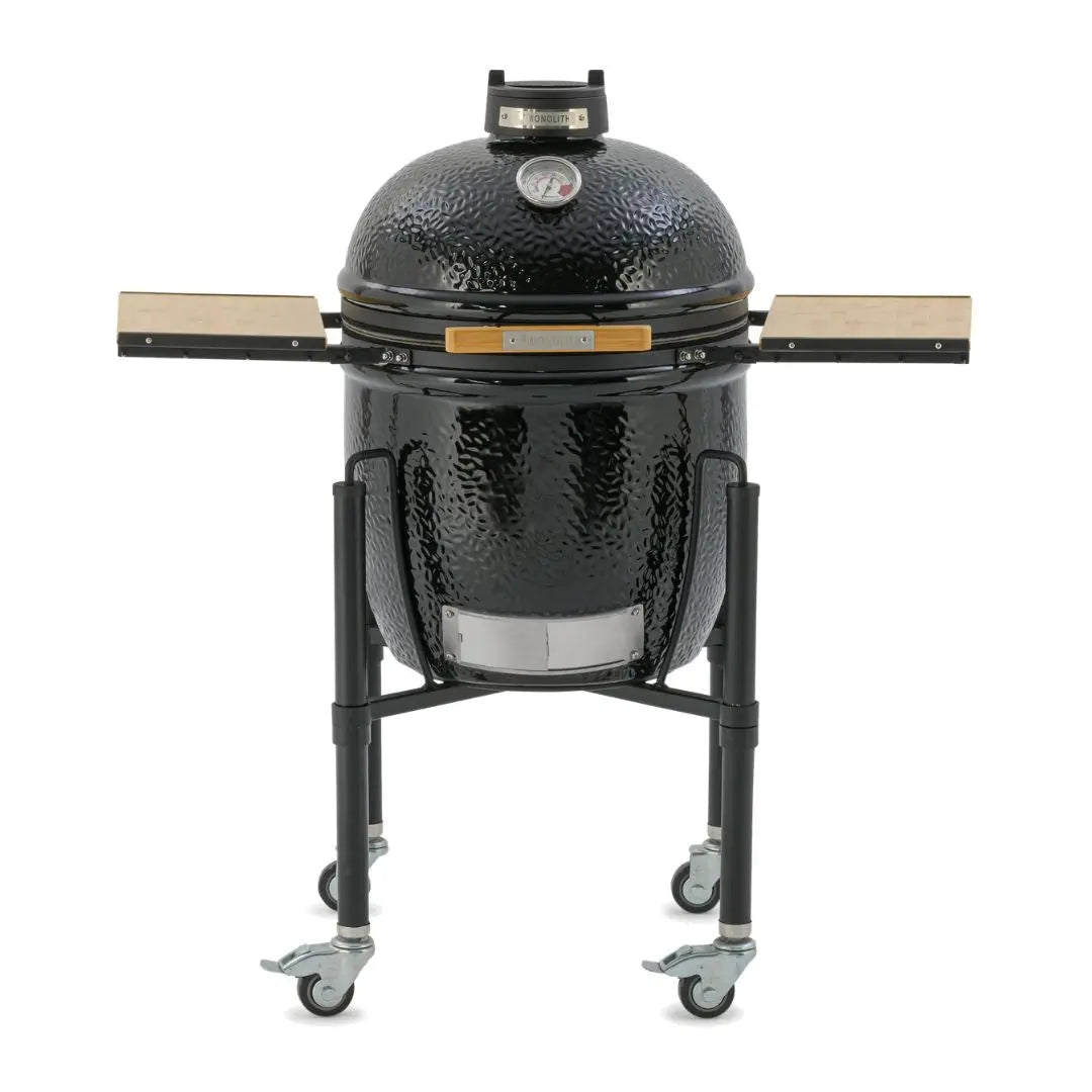 Monolith ONE 55cm Black ceramic grill on wheels with wooden side tables front view on a white background