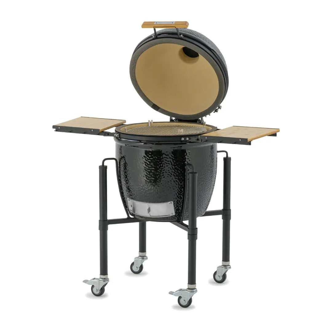 Monolith ONE 55cm Black ceramic kamado grill on wheels with wooden side tables side view on a white background