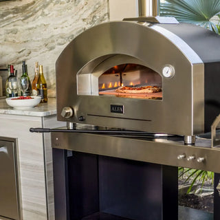 Stainless steel Alfa Futuro 4 Pizze Hybrid Gas Pizza Oven with a pizza inside, set against a kitchen backdrop.