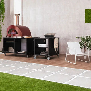 Outdoor setting with Alfa Pizza Oven Modular Cooking Station 160 with chair and plants.