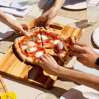 Alfa pizza being shared by family at dining table