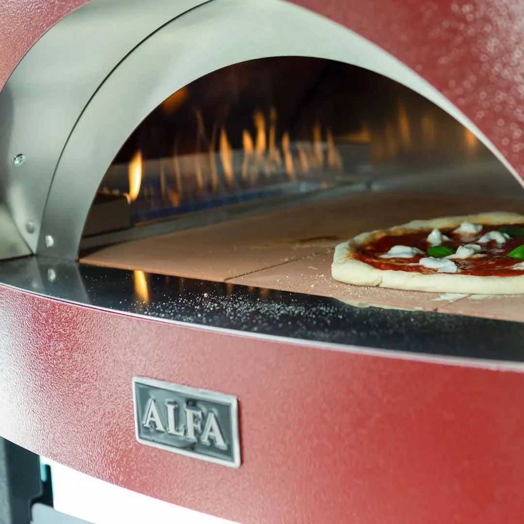 Antique Red Alfa Moderno Pizze Hybrid Gas Pizza Oven with a pizza and flames inside