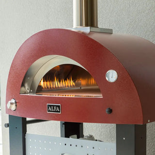 Antique Red Alfa Moderno Pizze Hybrid Gas Pizza Oven with a silver chimney outside