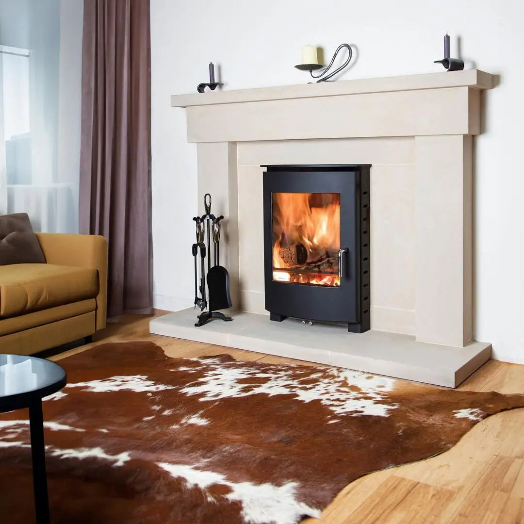 Dean Forge 105 Eco Inset Stove - 5kW in stone fire surround with cow hide rug