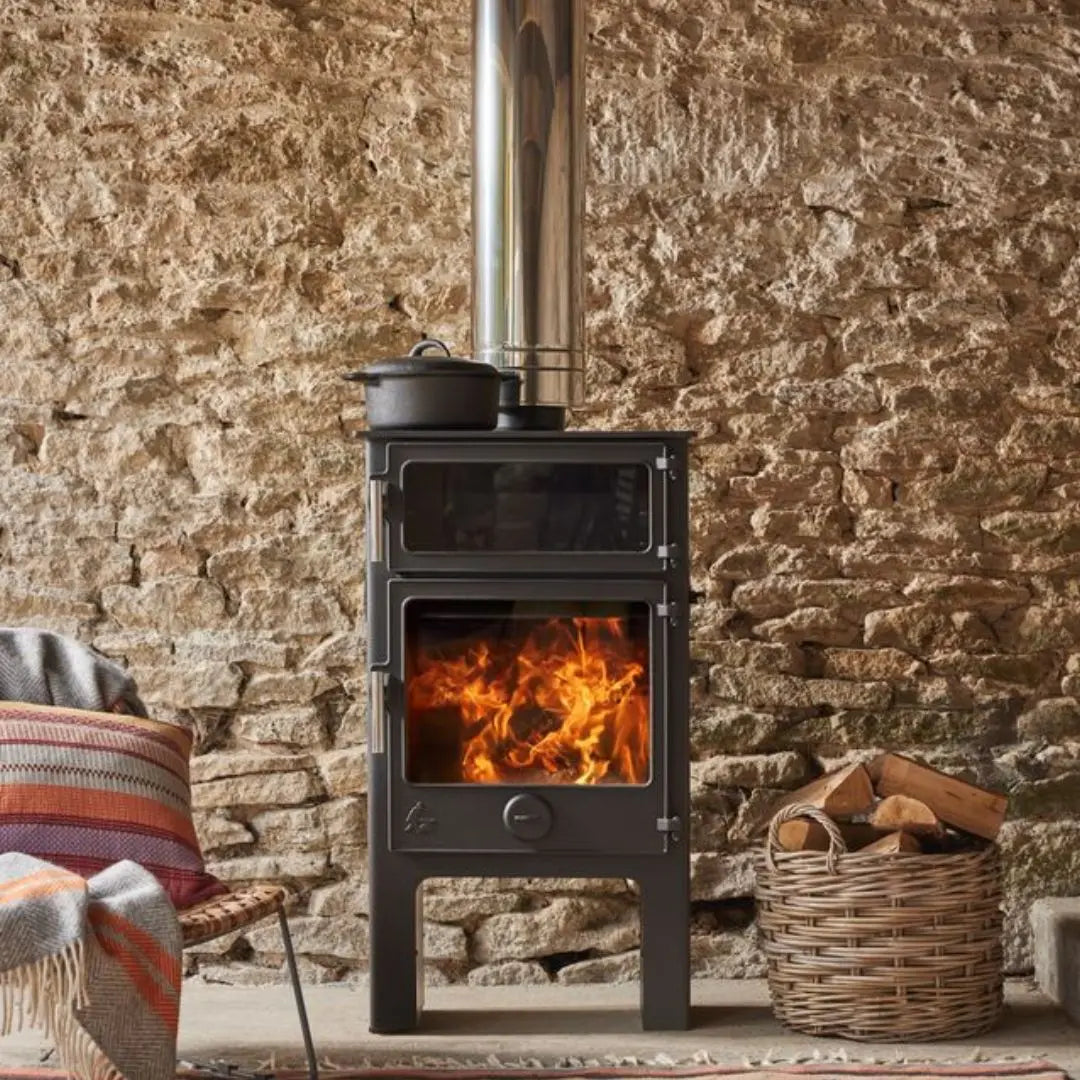 Dean Forge Baker 8 Eco High Stove - 8kW with stone wall and log basket and chair