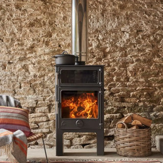 Dean Forge Baker 8 Eco High Stove - 8kW with stone wall and log basket and chair