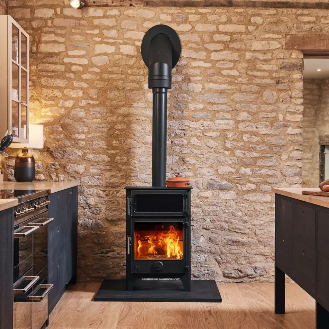 Dean Forge Baker 8 Eco Baking Stove - 8kW in kitchen with stone wall