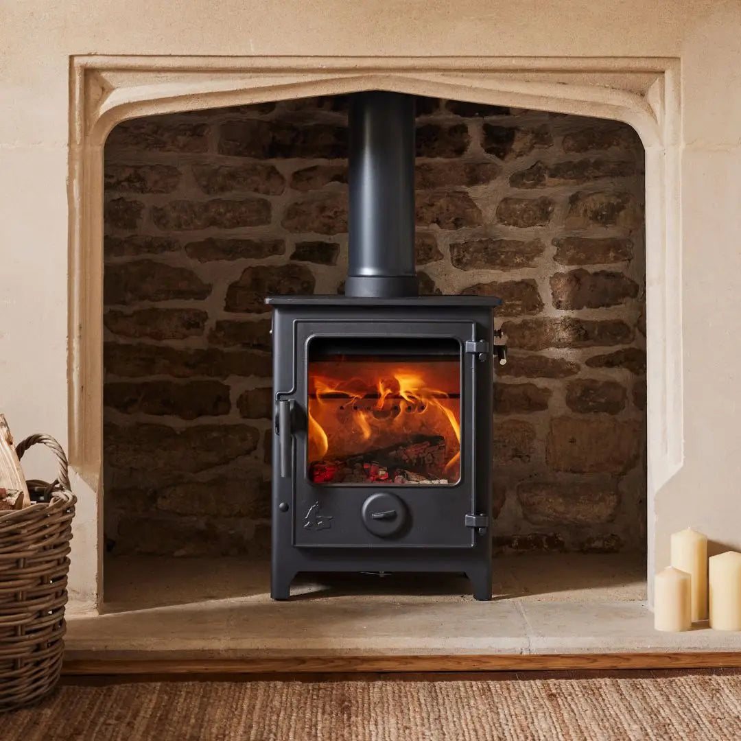 Dean Forge Dartmoor 5 Eco Log Burner Stove in brick fireplace with marble surround