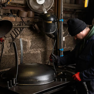 Person welding Dean Forge Firebowl Fire Pit in Devon workshop