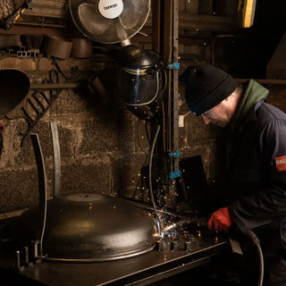 Person welding Dean Forge Firebowl Fire Pit in Devon workshop