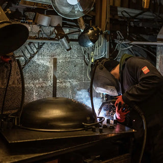 Person welding Dean Forge Firebowl Fire Pit in Devon workshop