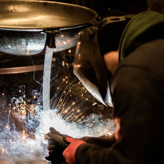 Person welding Dean Forge Firebowl Fire Pit in Devon workshop
