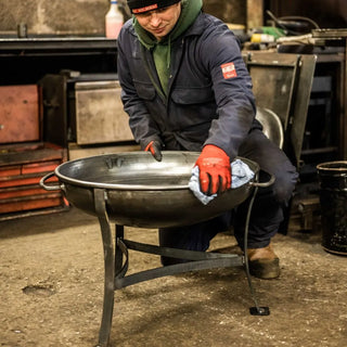 Person polishing Dean Forge Firebowl Fire Pit in Devon workshop