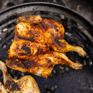 Roasted chicken on Dean Forge Moorland Firebowl Swing Arm with charred marks