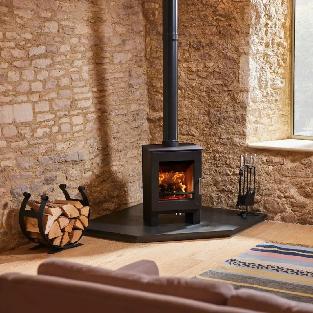Dean Forge Sherford 5 Eco Stove - 5kW on corner hearth with log holder against stone wall