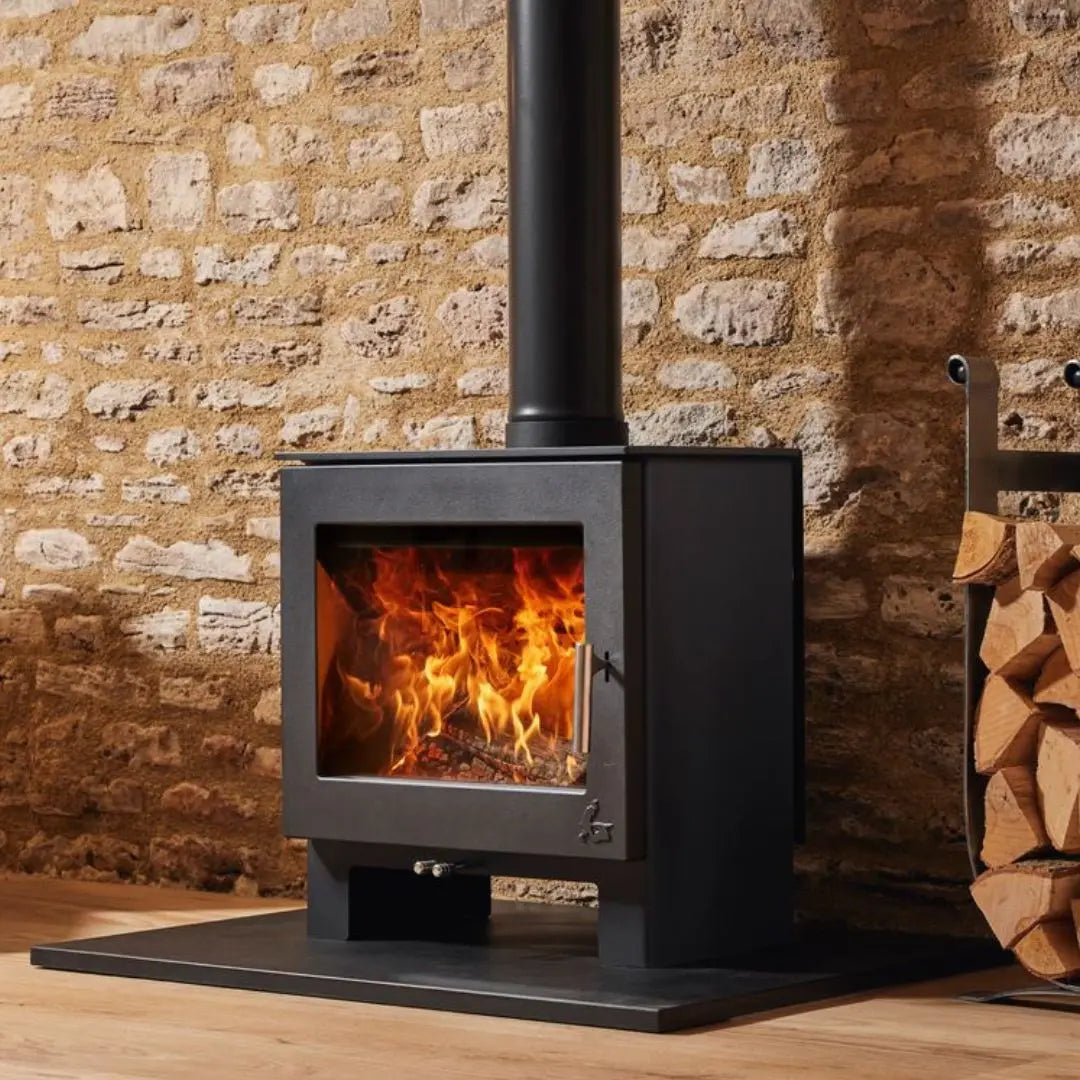 Dean Forge Sherford 8 Eco Stove - 8kW on black hearth against stone wall