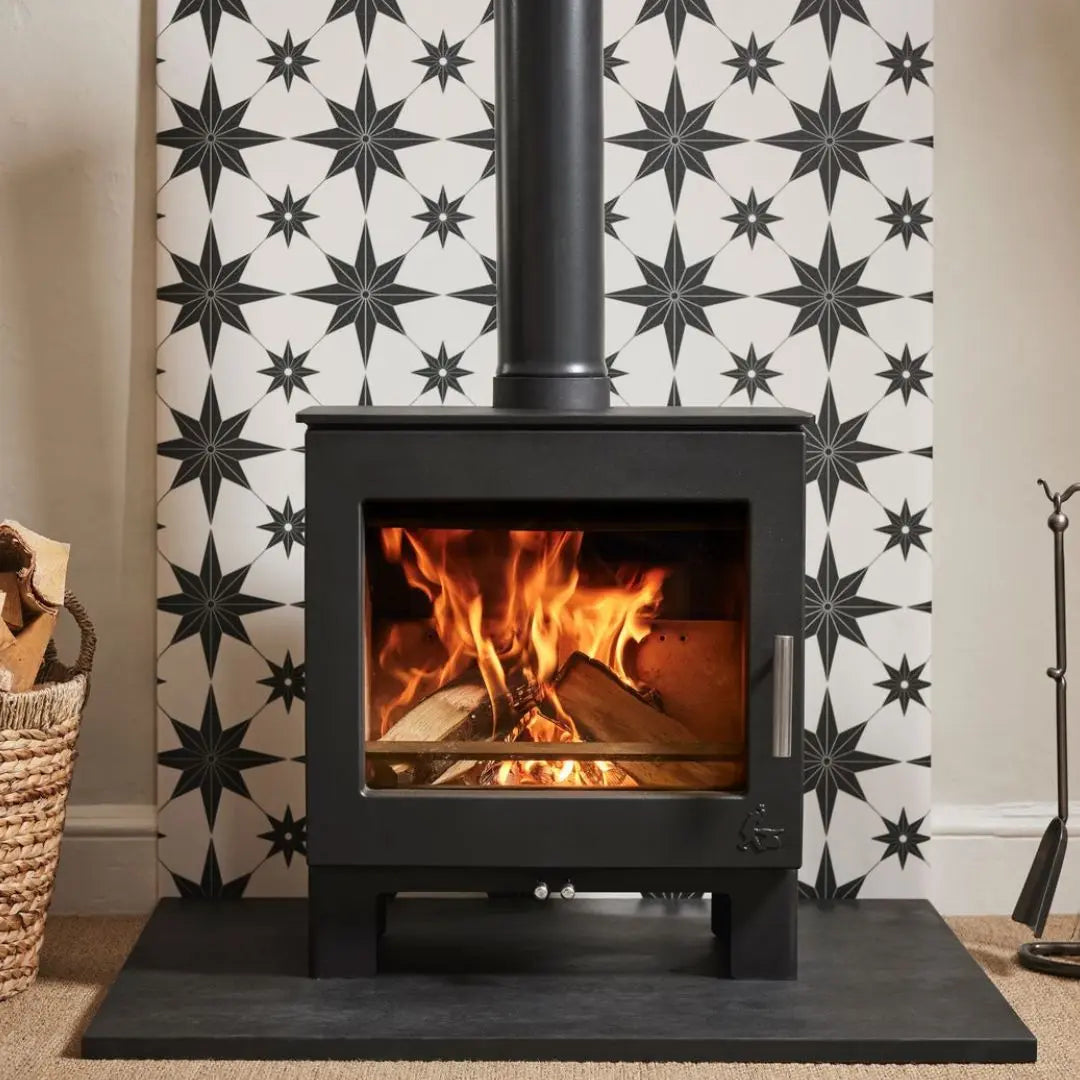 Dean Forge Sherford Slimline 5 Eco Stove - 5kW against patterned tile wall and black hearth