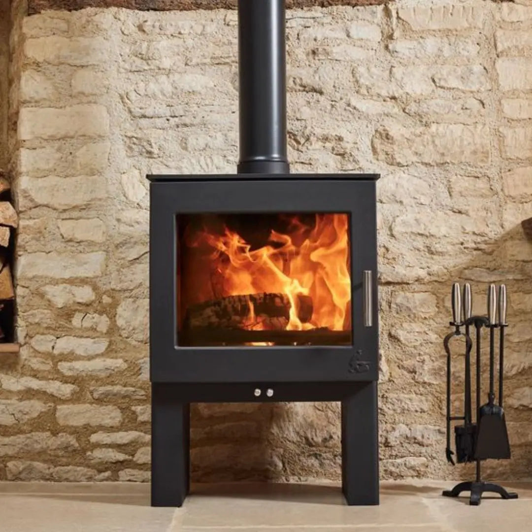 Dean Forge Sherford Slimline 5 High Eco Stove - 5kW against stone wall with cast iron companion set