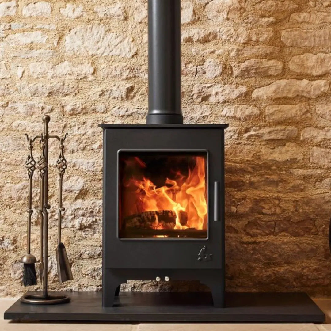 Dean Forge Woodbury 5 Eco Stove - 5kW on black hearth against stone wall