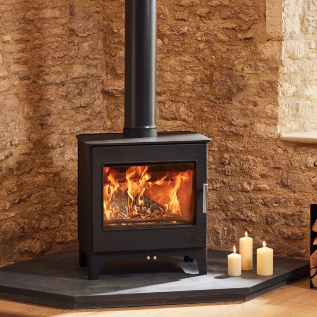 Dean Forge Woodbury 8 Eco Stove - 8kW on black hearth with candles burning