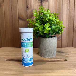 Tube of eco3spa test strips on a wooden surface with a potted plant in the background