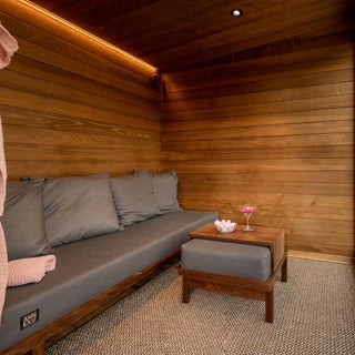 Wooden Lounge with a bench and small table, featuring a pink glass.