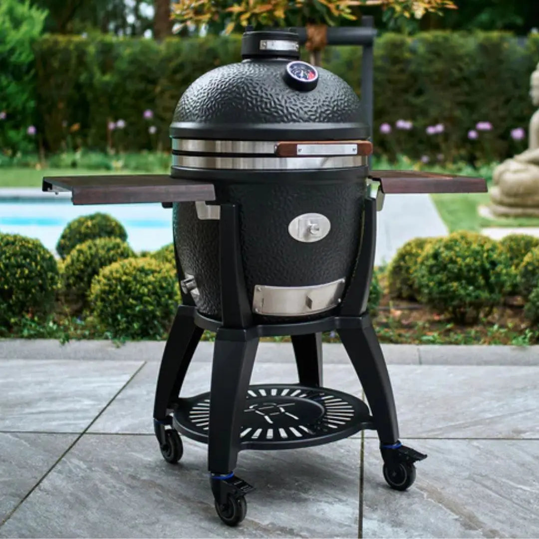 Monolith Avantgarde 55cm Black Kamado grill with cart in patio setting