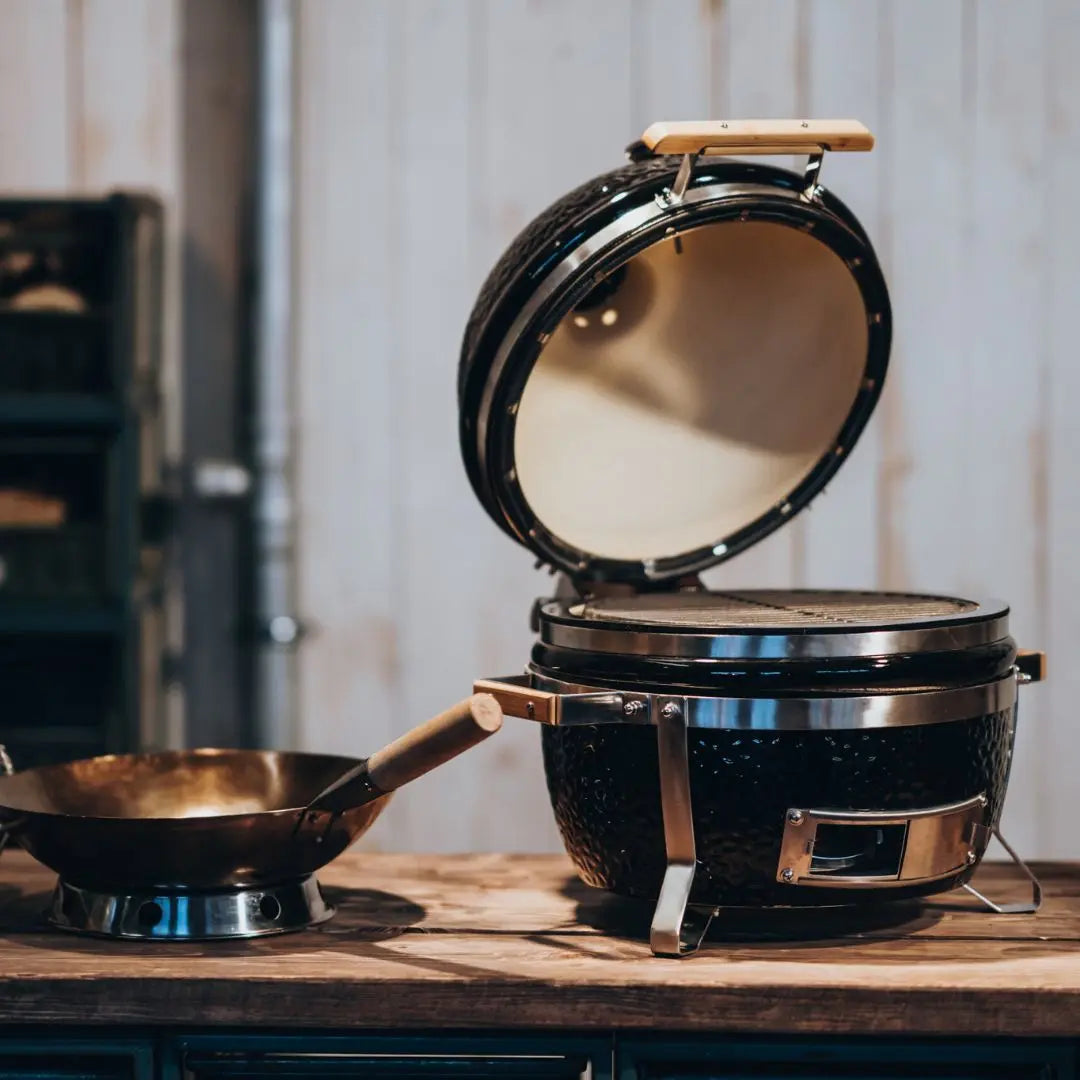 Monolith ICON 53cm Black ceramic kamado grill on a wooden surface