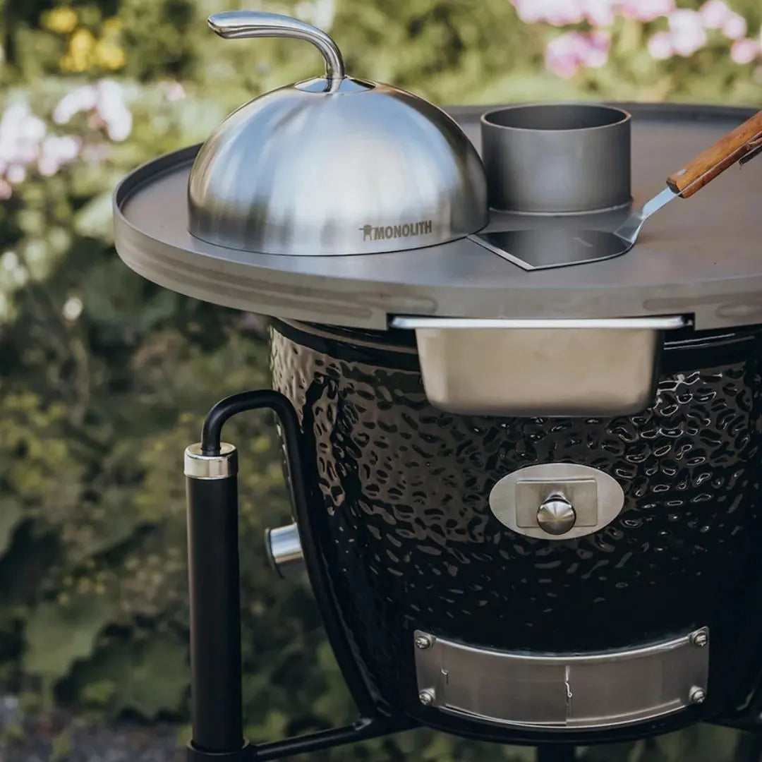 Monolith Kamado Grill Fireplate closeup with spatula and cloche