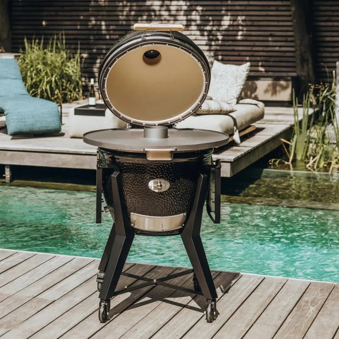 Monolith Kamado Grill Fireplate setup in front of pool