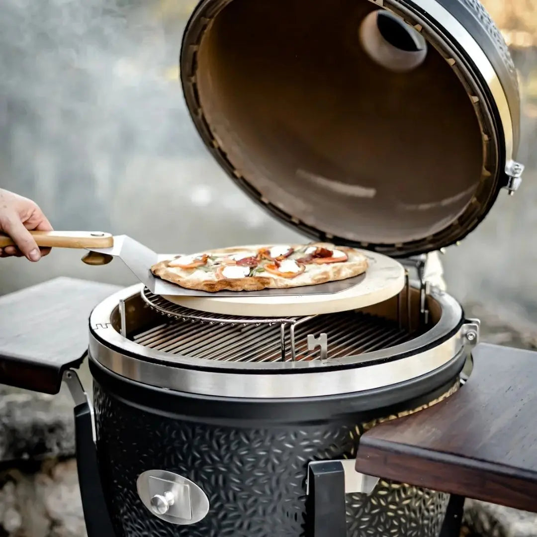 Monolith Kamado Grill Pizza Stone sliding pizza onto grill