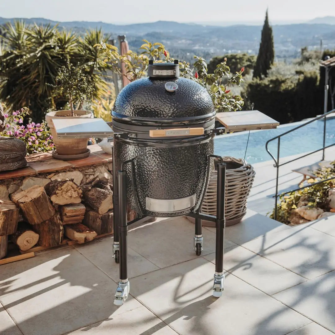 Monolith ONE 55cm Black ceramic grill on wheels with wooden side tables on outdoor patio