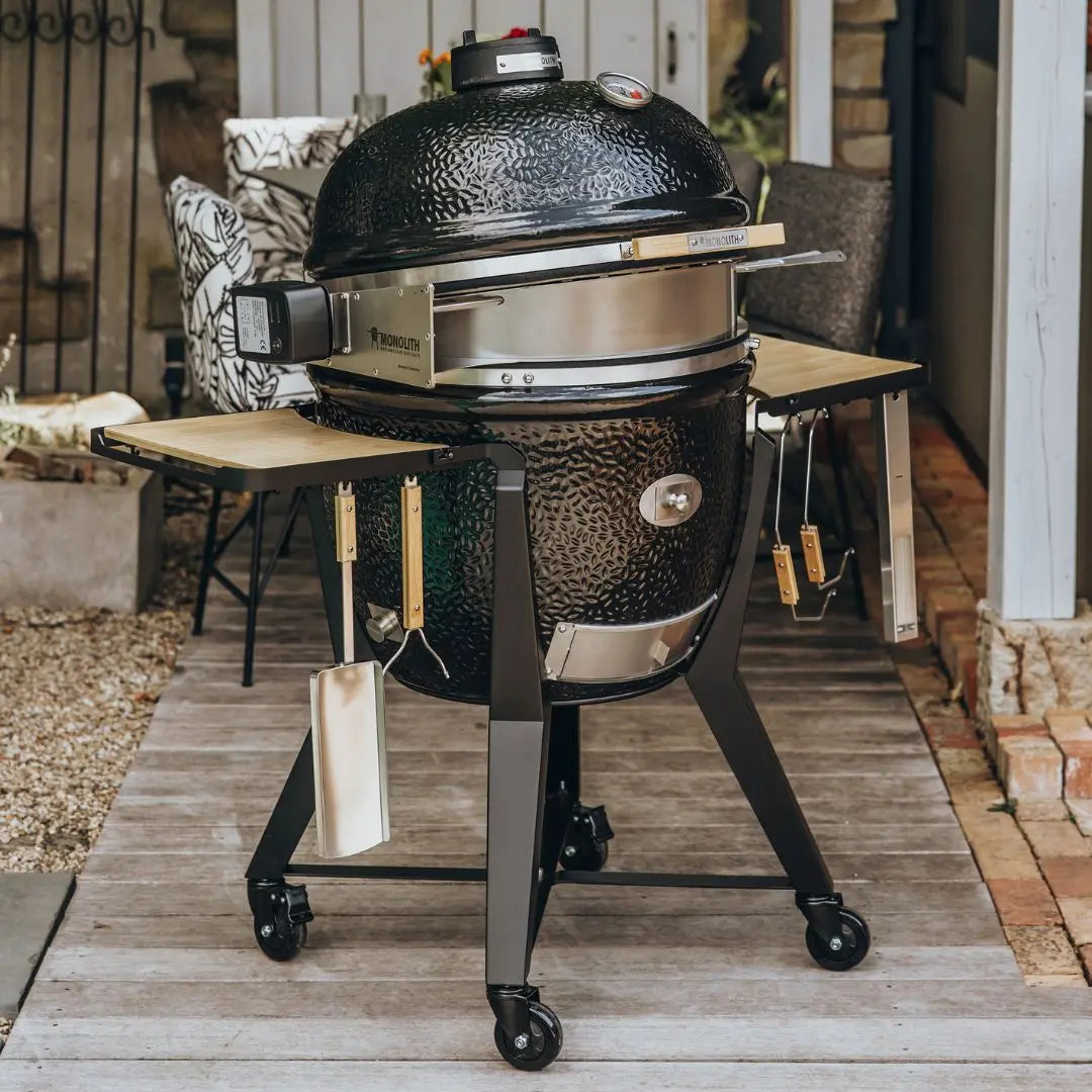 Monolith TWO 66cm Black kamado grill with cart, accessories and rotisserie fitting on decking