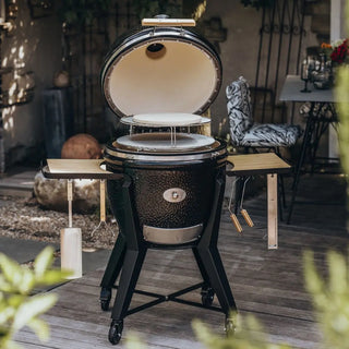 Monolith TWO 66cm Black kamado grill with cart, accessories and pizza stone on patio