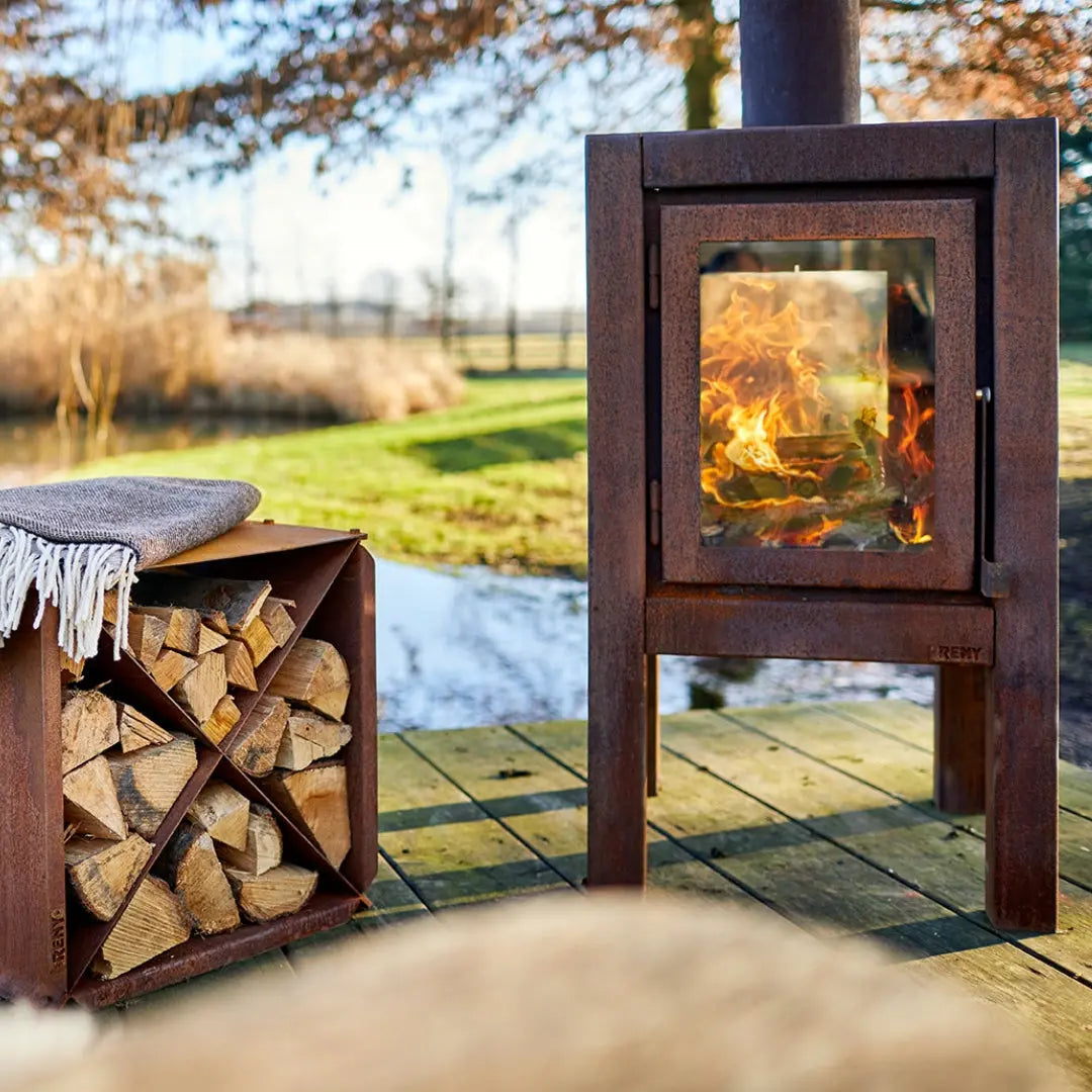 RB73 Quaruba XL Outdoor Fireplace - CorTen Steel Wood Burner on outdoor patio setting