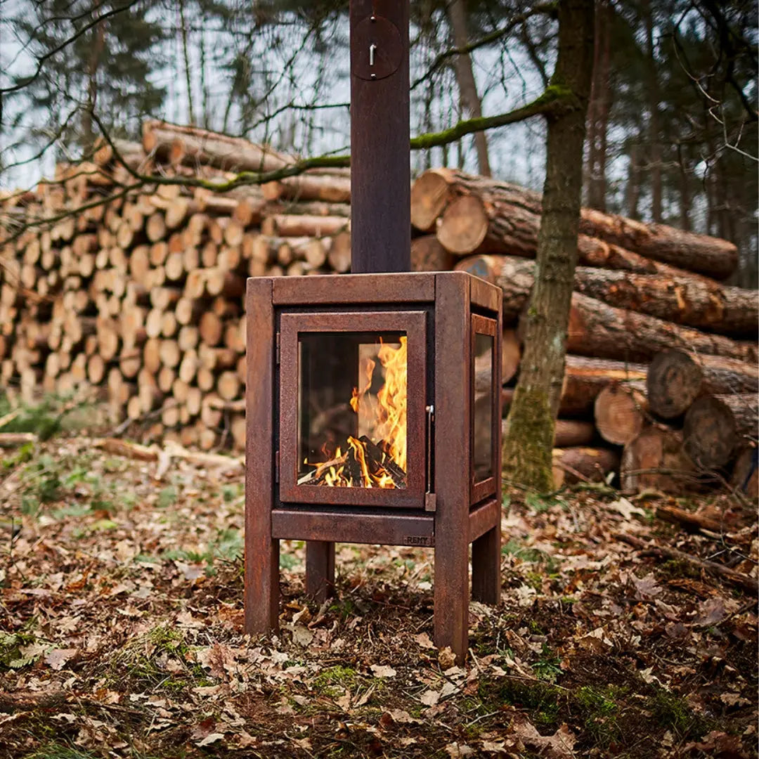 RB73 Quaruba XL Outdoor Fireplace - CorTen Steel Wood Burner in forest setting