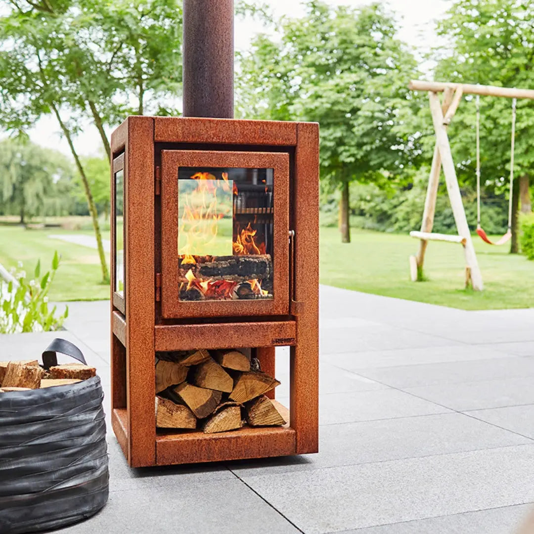 RB73 Quaruba XL Mobile Outdoor Fireplace - CorTen Steel Wood Burner on outdoor patio setting