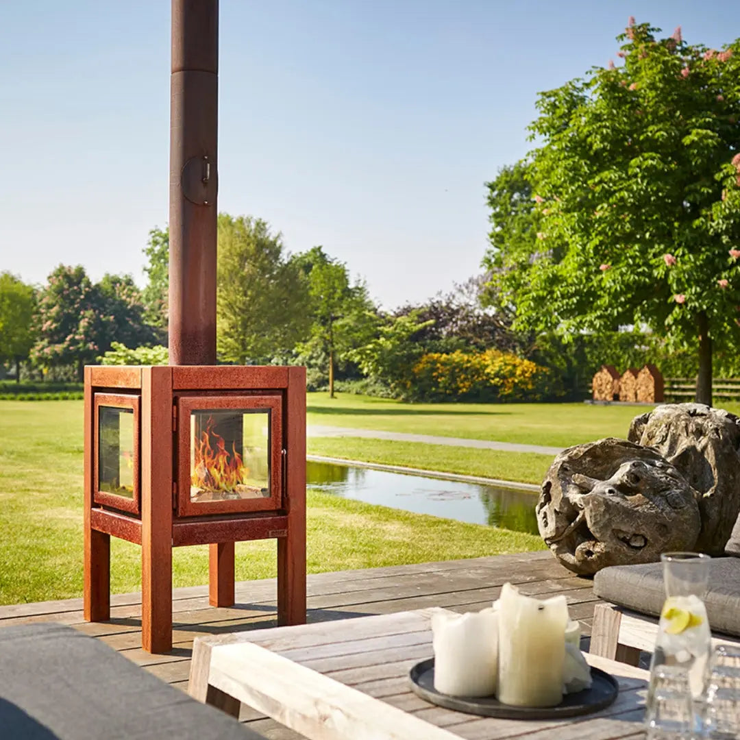 RB73 Quaruba L Outdoor Fireplace – CorTen Steel Wood Burner with 4 sided glass on outdoor patio setting