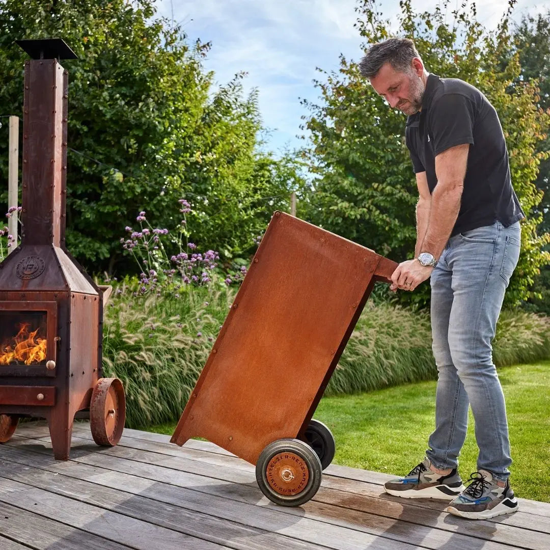 Person wheeling RB73 Ker Mobile Corten Steel Log Storage
