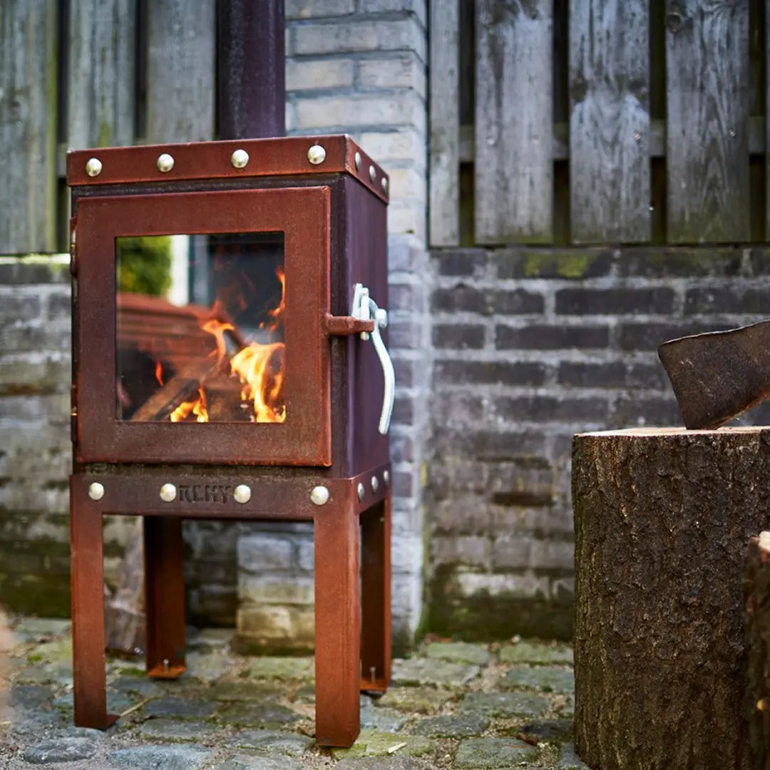 RB73 Piquia Outdoor Fireplace - Compact CorTen Steel Log Burner on outdoor patio setting