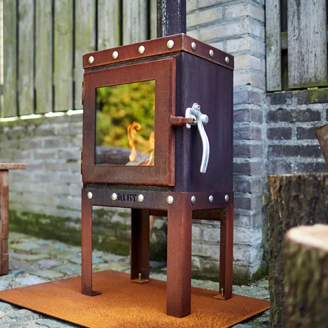 RB73 Piquia Outdoor Fireplace - Compact CorTen Steel Log Burner on outdoor patio setting