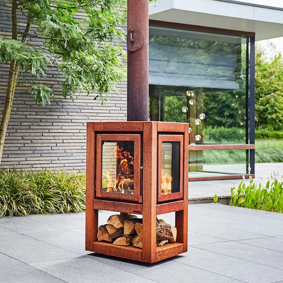 RB73 Quaruba XL Mobile Outdoor Fireplace - CorTen Steel Wood Burner on outdoor patio setting