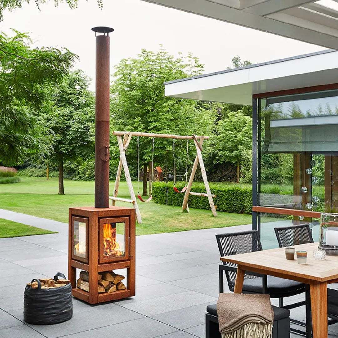 RB73 Quaruba XL Mobile Outdoor Fireplace - CorTen Steel Wood Burner on outdoor patio setting