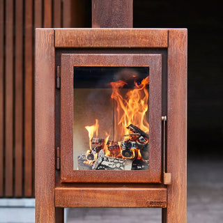 RB73 Quaruba XL Outdoor Fireplace - CorTen Steel Wood Burner on outdoor patio setting