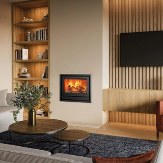 Stovax Riva2 66 Inset Wood Burning Stove - 8.1 kW on beige chimney wall