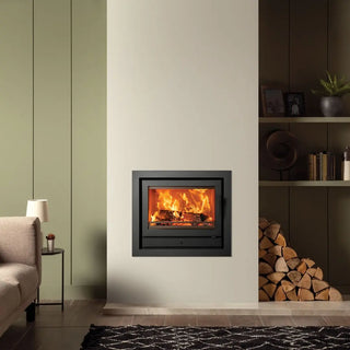 Stovax Riva2 66 Inset Wood Burning Stove - 8.1 kW on stone coloured chimney wall
