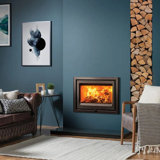 Stovax Vogue 700 Inset Wood Burning Stove - 7 kW on teal chimney wall