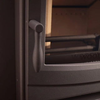 Close-up of black Woodwarm machined teardrop handle on wood burning stove